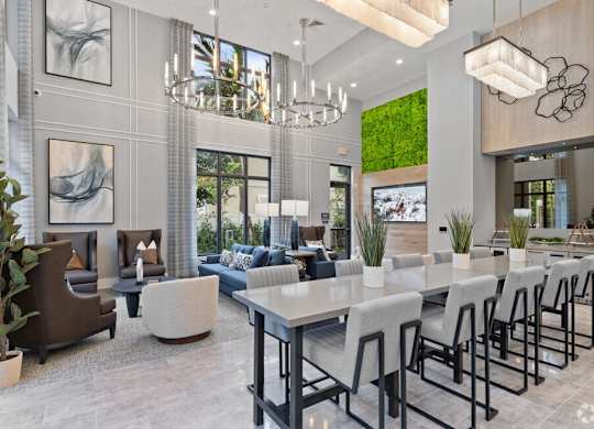 a dining room and living room with a long table and chairs at Mayla Pompano, Pompano Beach, FL