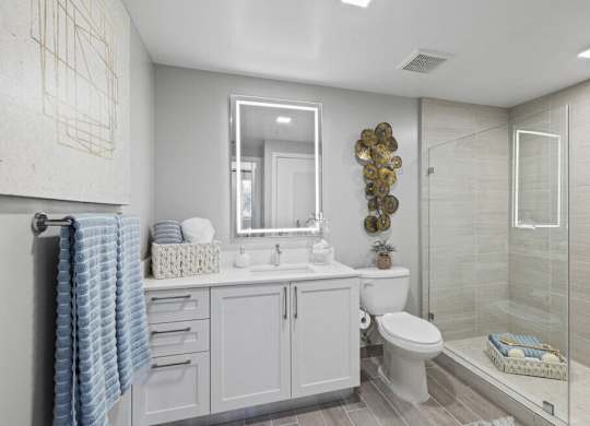 a white bathroom with a shower toilet and sink at Mayla Pompano, Pompano Beach, 33062