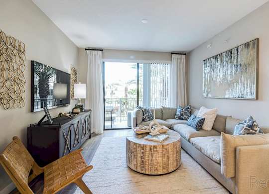 A living room with a wooden chair and a white couch at Mayla Pompano, Pompano Beach, 33062
