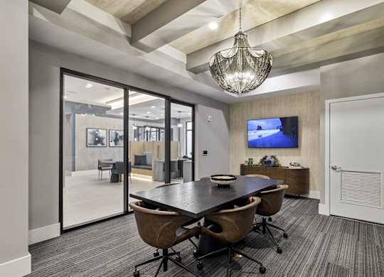 A conference room with a large table and chairs at Mayla Pompano, Pompano Beach, FL