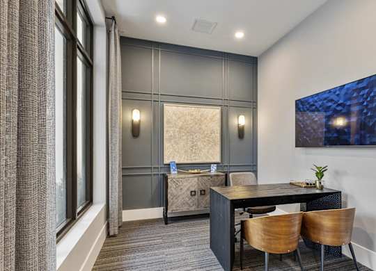 A modern dining room with a dark table and chairs at Mayla Pompano, Pompano Beach, FL, 33062