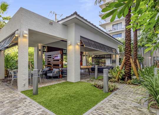 A modern house with a patio and a barbecue area at Mayla Pompano, Pompano Beach