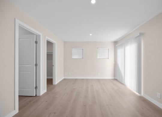 A room with wooden floors and white walls.