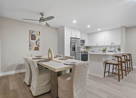 A modern kitchen with a dining table and chairs at Tamarack Sands Apartment Homes, Carlsbad, CA