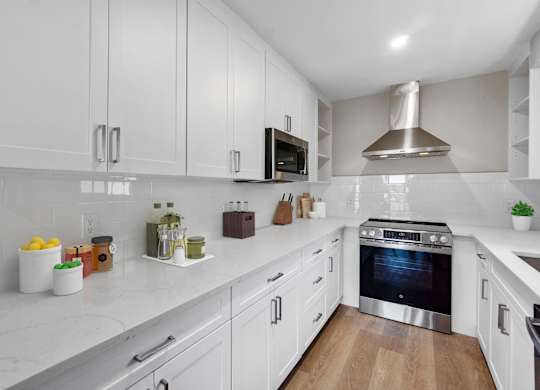 A modern kitchen with white cabinets and a stainless steel oven.at Ocean Edge @ Laguna Beach, California, 92651