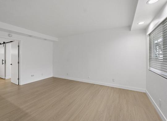 A room with a sliding door and wooden flooring. at Torrance Gateway Apartments, Torrance, 90501