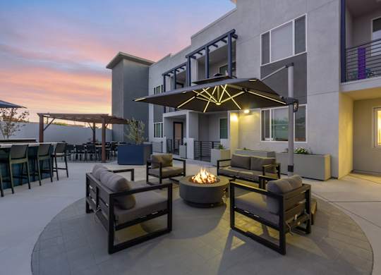 A patio with a fire pit and seating area.at The Reserve La Mirada, California
