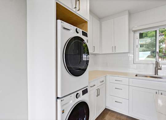 A white washing machine in a kitchen.