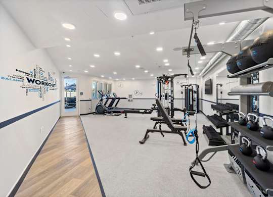A gym with a variety of equipment including weights and machines.at The Reserve La Mirada, California, 90638