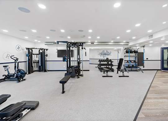 A gym with a variety of equipment including treadmills, weights, and exercise machines.at The Reserve La Mirada, La Mirada, California