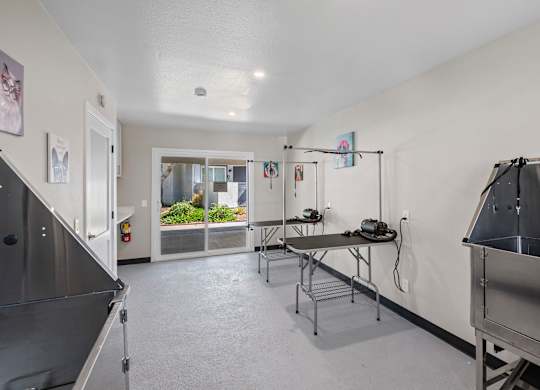 A kitchen area with a table and chairs.