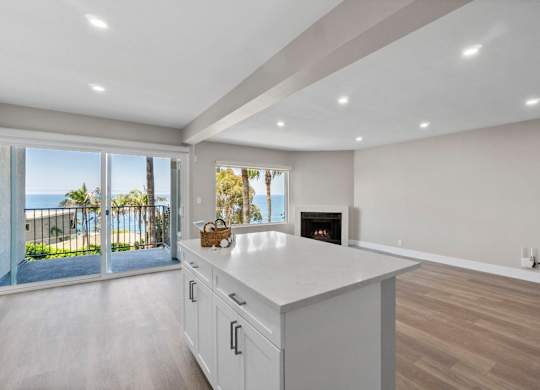 A modern kitchen with a view of the beach.