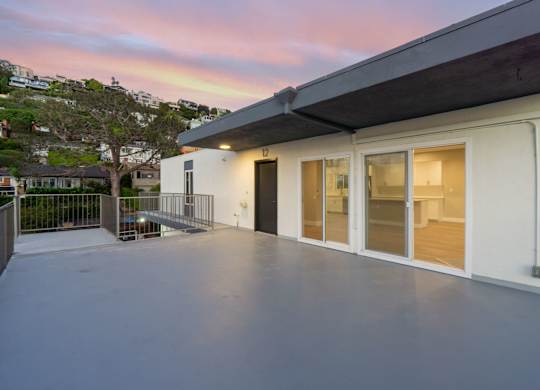 A modern house with a white exterior and a balcony.at Ocean Edge @ Laguna Beach, Laguna Beach California