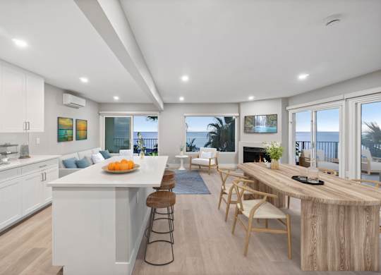 A modern kitchen with a dining table and chairs.at Ocean Edge @ Laguna Beach, Laguna Beach, CA