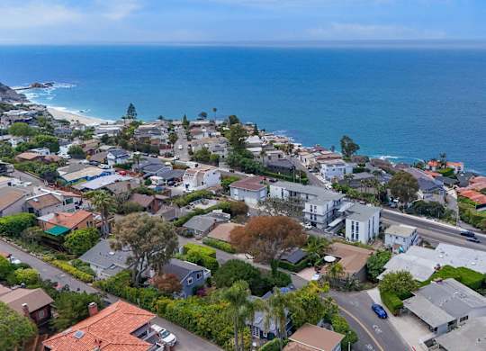 A coastal residential area with houses and a road.