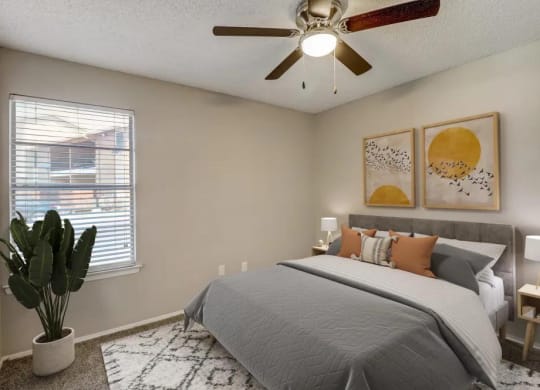 a bedroom with a bed and a ceiling fan