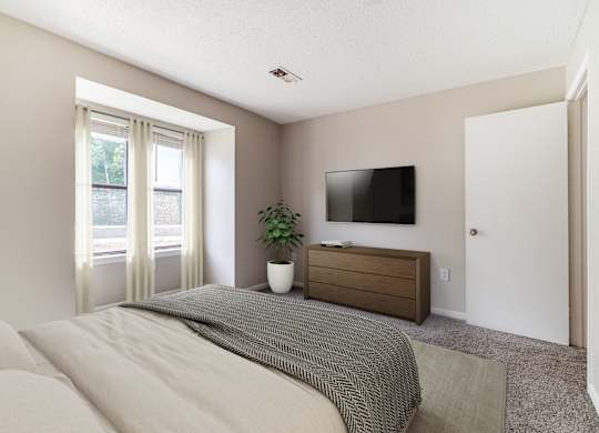 A bedroom with a bed, a dresser, and a window.