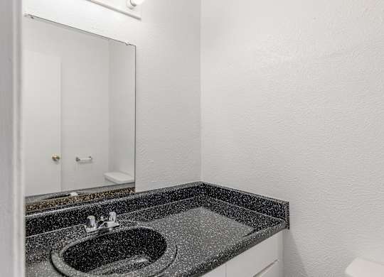 A bathroom with a sink and mirror. at Carisma, Dallas, TX, 75240