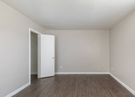 A room with a white door and wooden flooring. at Carisma, Dallas, TX, 75240