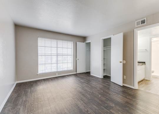 A room with a window and wooden floors.at Carisma, Dallas, TX