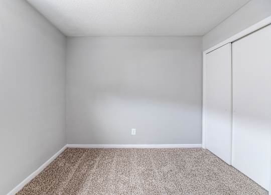 A room with a carpeted floor and a white wall.at Lauradale, Jacksonville