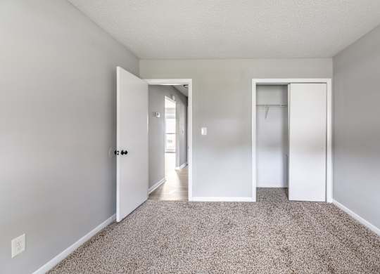 A room with a carpeted floor and two doors.at Lauradale, Jacksonville, 28540