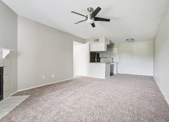 A room with a ceiling fan and a carpeted floor.