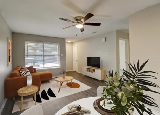 a living room with a couch and a ceiling fan