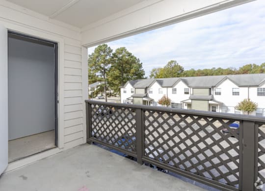 the view from the balcony of a home with a garage door open
