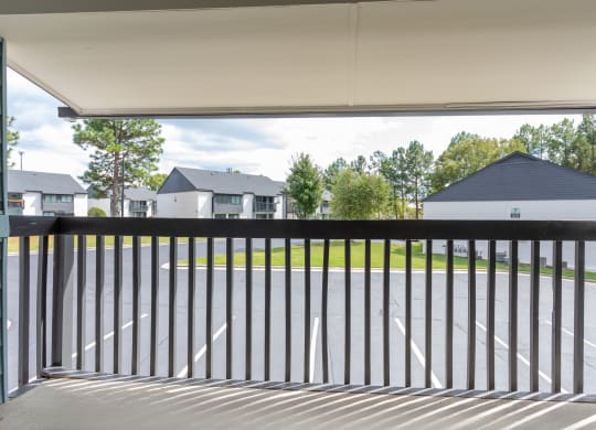 the deck has a view of the yard and the houses in the background