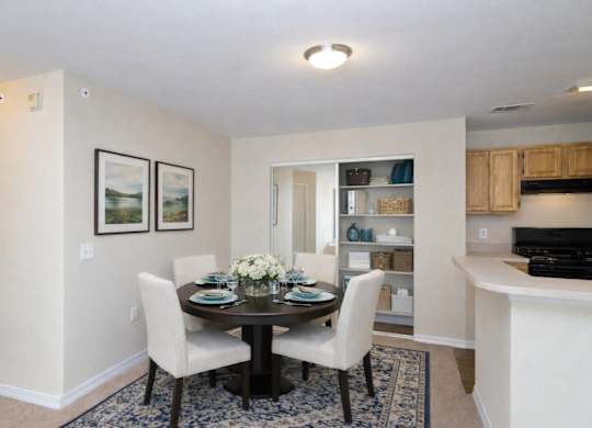 A dining room with a table set for two.