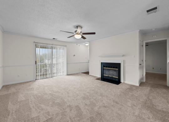 living room with fireplace , ceiling fan, and large patio window at Rosewood at Colony Square, Rocky Mount, NC