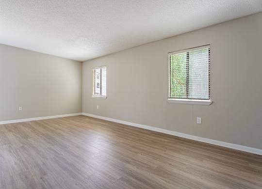 A room with a window and a wooden floor. at Rosen at North Hills, Raleigh