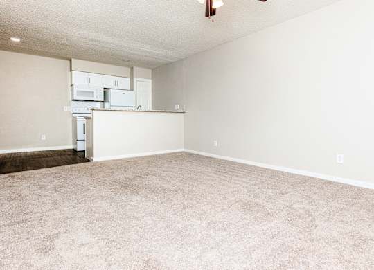 A white wall with a fridge and microwave on top of it.