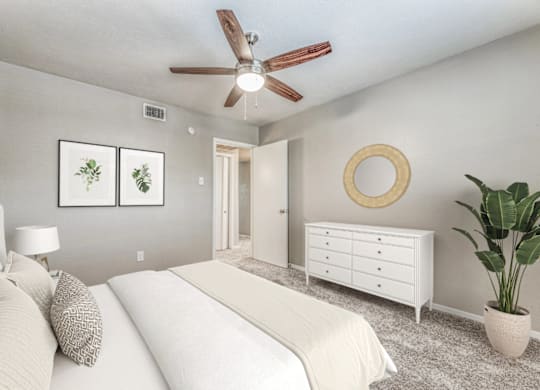 Serene bedroom with white dresser and mirror at Northwood Heights Apartments, Dallas, Texas