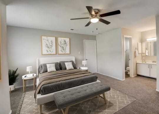 a bedroom with a bed and a ceiling fan