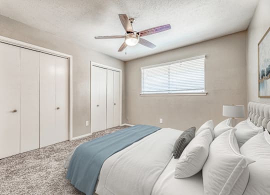 Spacious bedroom with dual closets and carpeting at Northwood Heights Apartments, Texas