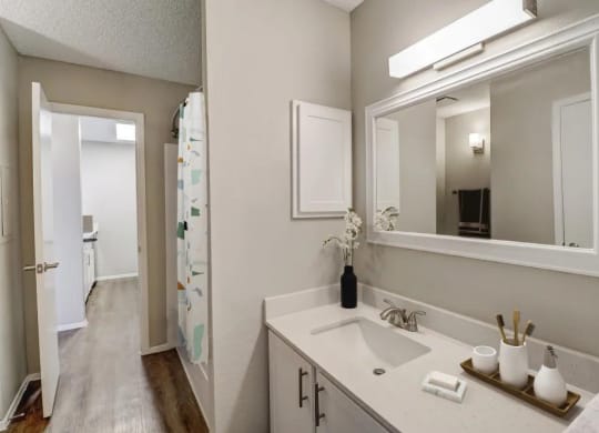 an empty bathroom with a sink and a mirror