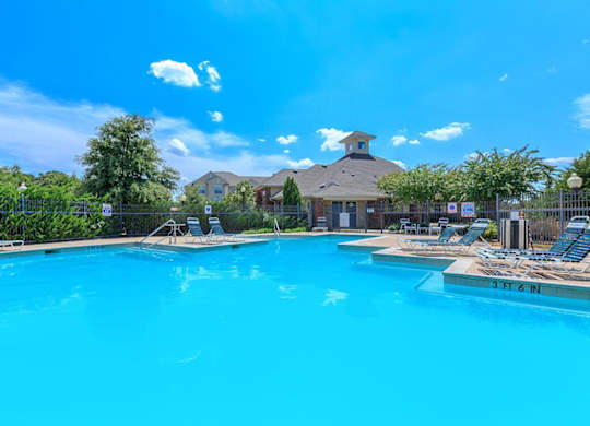 A large swimming pool with a depth of 3 feet 6 inches at Addison Park Apartments in Arlington, TX.