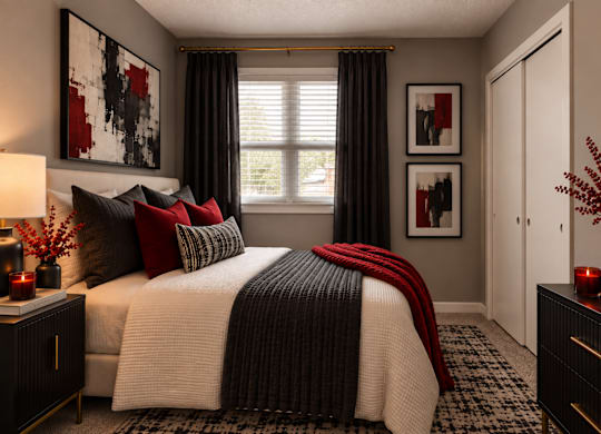 A bedroom with a large bed and a painting on the wall.