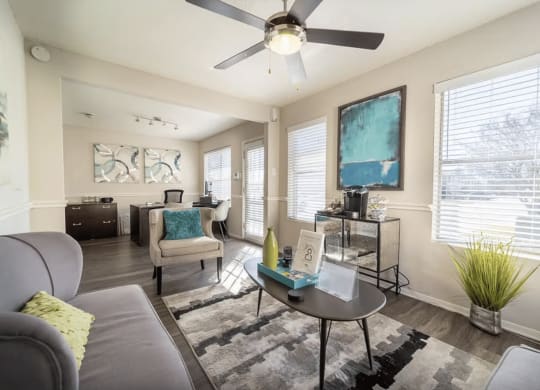 a living room with furniture and a ceiling fan