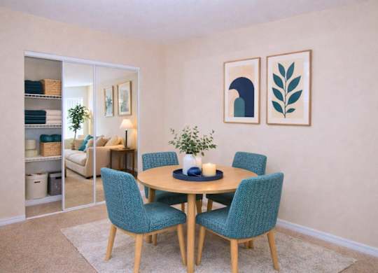 A dining room with a table set for two and a plant on the table.