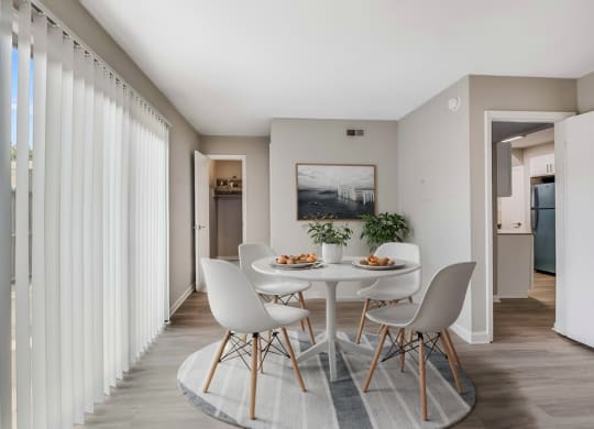 a dining room with a white table and chairs