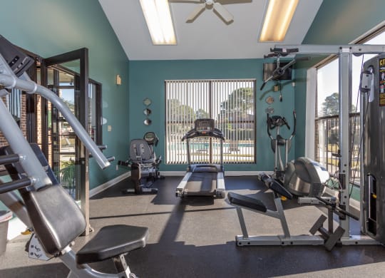 a gym with exercise equipment and a window