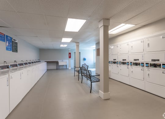 a large room with a row of mailboxes and benches