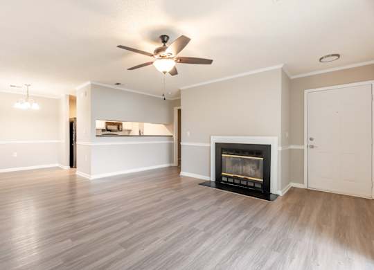 A living room with a fireplace and a ceiling fan. at Rosewood at Colony Square, North Carolina, 27804