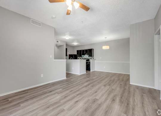 A room with a ceiling fan and lighting fixtures.