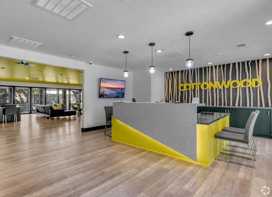 A reception area with a yellow counter and a sign that says Cottonwood.