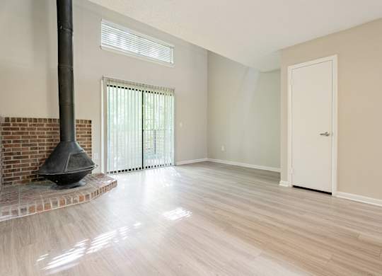 A room with a fireplace and a door. at Rosen at North Hills, Raleigh, NC, 27609