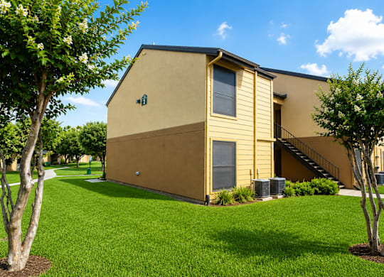 Two story apartment building with exterior staircase at Ridgeview Apartments, Sherman, TX